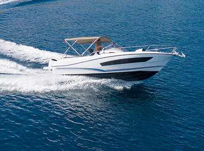A photo of a speed boat creating a wake, banking to the left, on a calm body of water